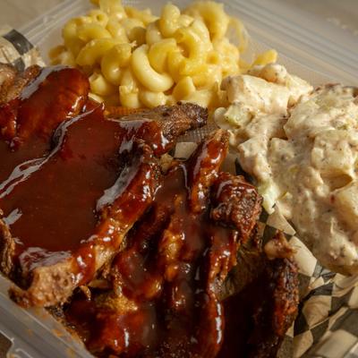Tri-tip served with sides of potato salad and mac and cheese.