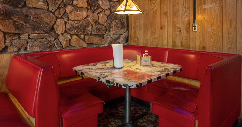 Interior space, upholstered round dining booth in the corner