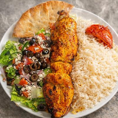 Regular Chicken plate served with rice, Greek pita bread, roasted tomato and side salad.