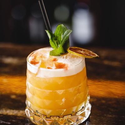 Mai Thai cocktail garnished with mint spring and dried lime wheel.