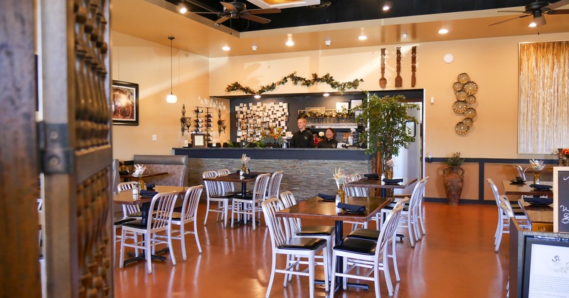 Diner area, tables and chairs, food counter behind