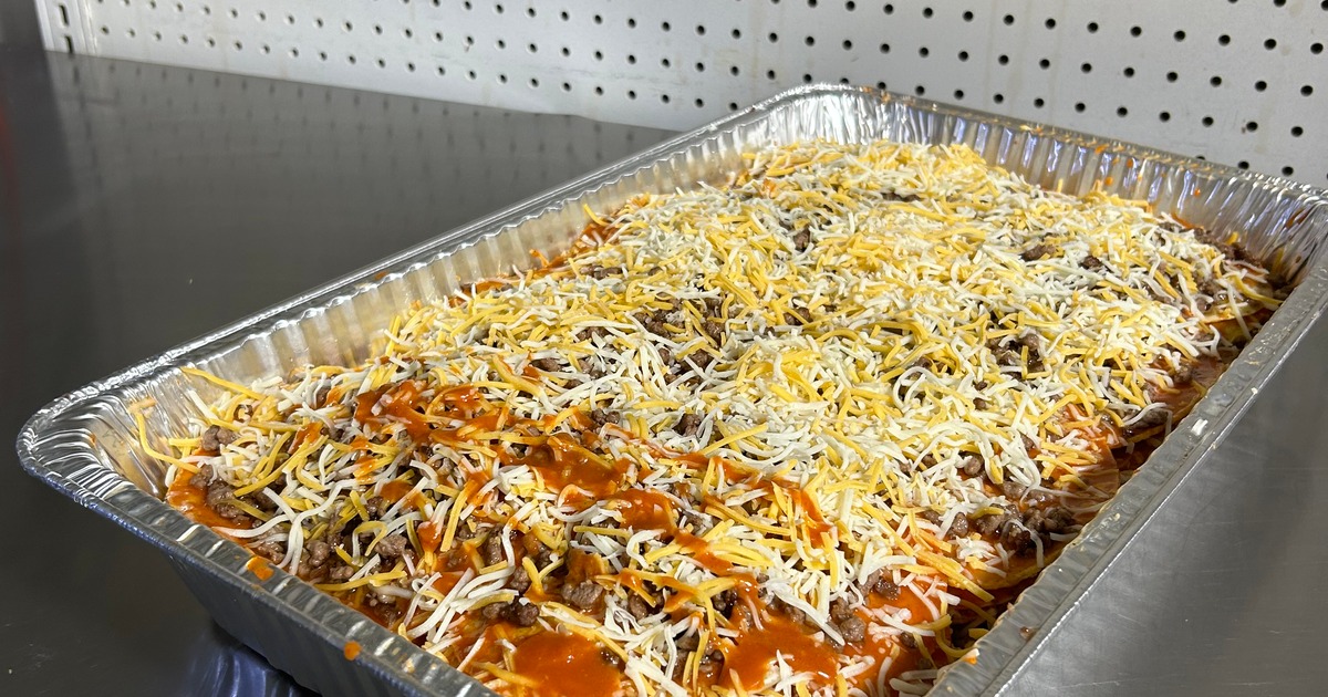 Cheesy casserole prepared in an aluminum tray