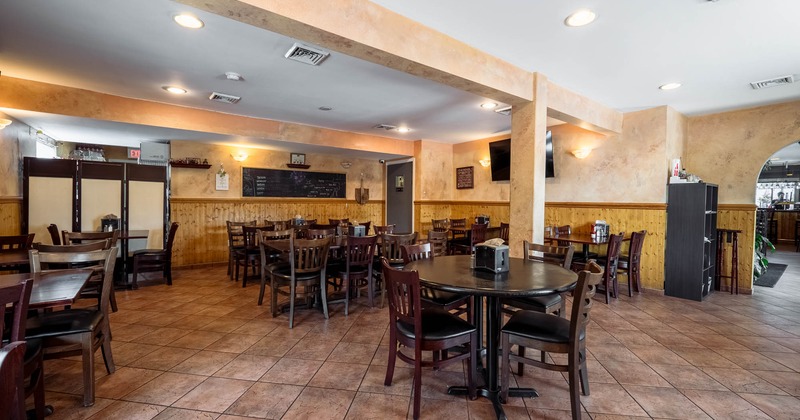 Interior of a restaurant with dark wooden tables and chairs