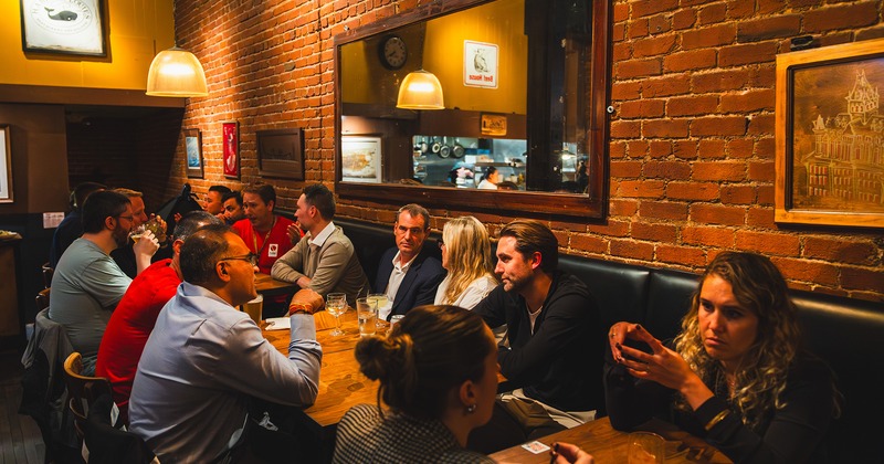 Interior, seating area full of guests chatting and enjoying their drinks