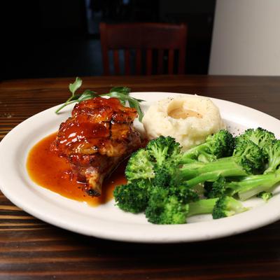 Pork Chop with apricot glaze  with mashed potatoes and broccoli.