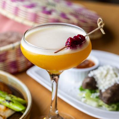 Passion fruit martini with skewered berries.