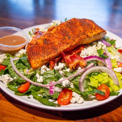 Salmon black and bleu salad, served, front view.