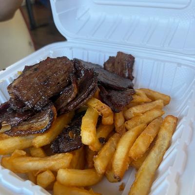 Grilled steak, grilled onions, and fries.