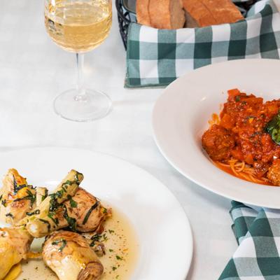 Sauteed artichokes and spaghetti and meatballs served with bread and white wine.