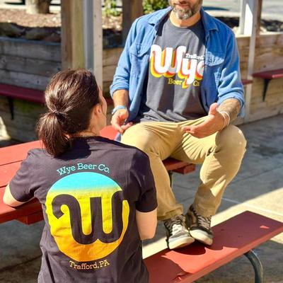 Guests talking at a table on the patio.