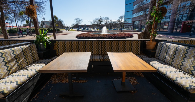 Exterior, sidewalk patio, tables,  square and fountain behind