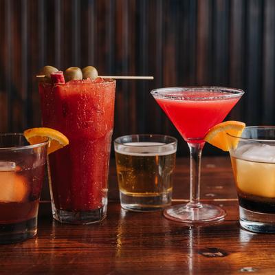 Colorful cocktails on a wooden table.