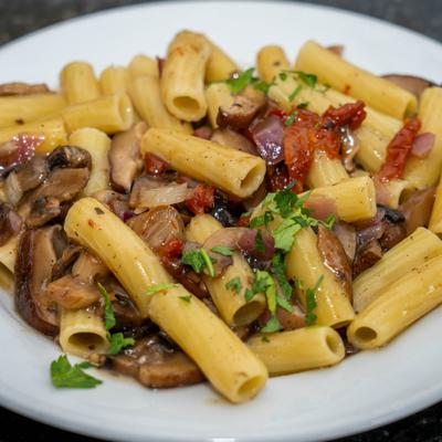 Wild mushrooms pasta with sun-dried tomatoes and herbs.