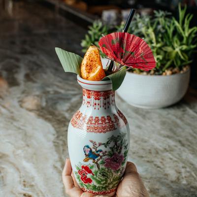 Signature cocktail served in a colorful glass with garnish.