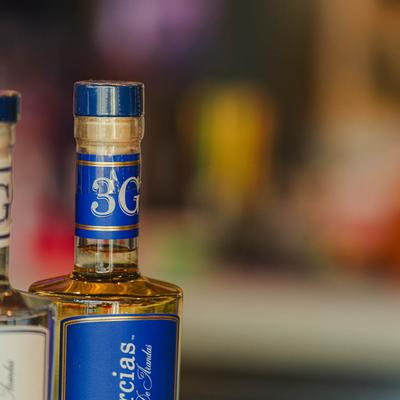 Close-up of a tequila bottle with a blue cap.