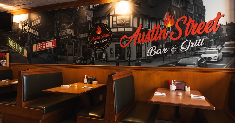 Interior -  wooden booths and a mural featuring "Austin Street Bar & Grill" signage