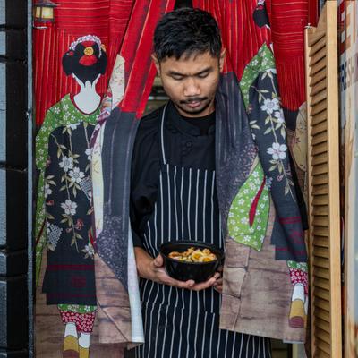 Chef carrying a bowl.