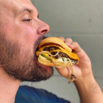 A person eating a burger