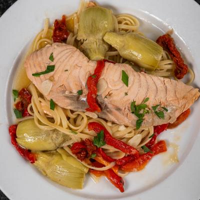 Salmon pasta with with artichoke hearts, sun-dried tomatoes, and roasted red peppers.