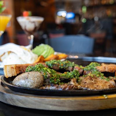 Pork belly, steak, chorizo and egg served withv  rice, beans, plantains and avocado.