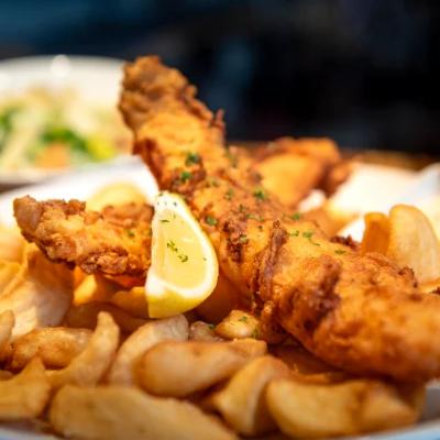Fish And Chips garnished with a lemon wedge, close-up.
