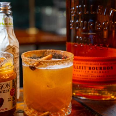 Apple Butter Old Fashioned cocktail, garnished with a cinnamon stick.