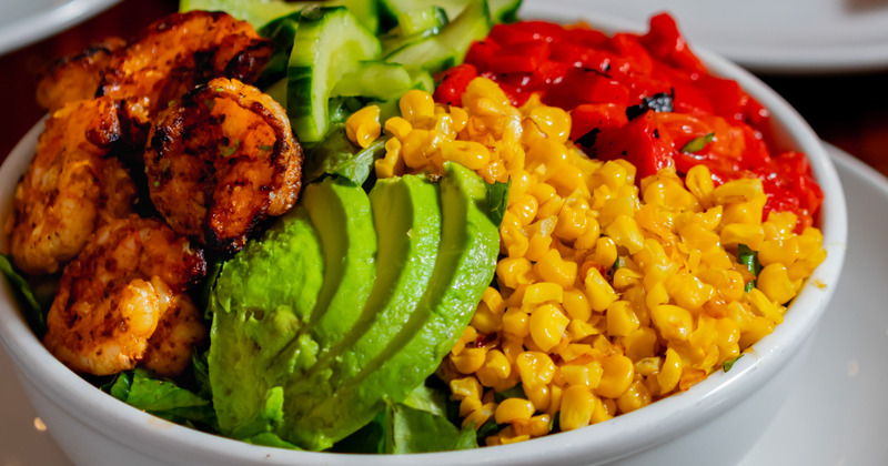 Cucumber, corn, pepper, avocado and shrimp dish