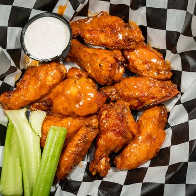 Sauced chicken wings served with celery and dip.