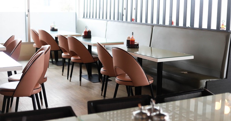 Interior, dining area, long padded banquette bench with tables and chairs