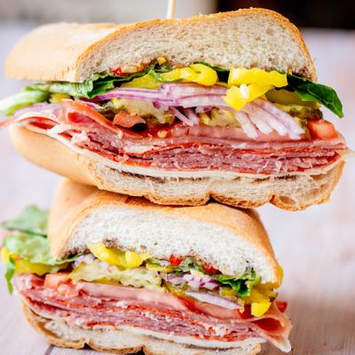 Italian Sub, with cold cuts, cheese, tomato, pickles, onions, lettuce, and pepperoncini.