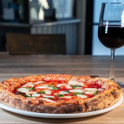 Margherita pizza, with a glass of red wine
