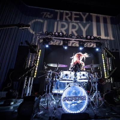 A drummer performing on stage.