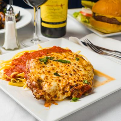 Chicke Parmigiana served with spaghetti in marinara sauce.