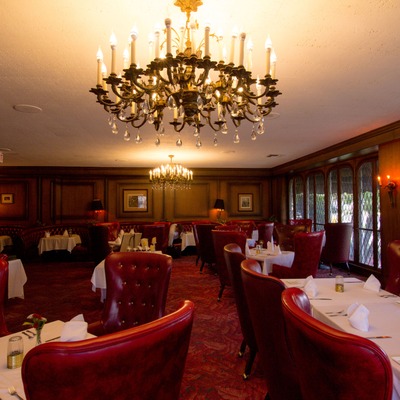 Elegant interior, with leather armchairs and a decorative chandelier.