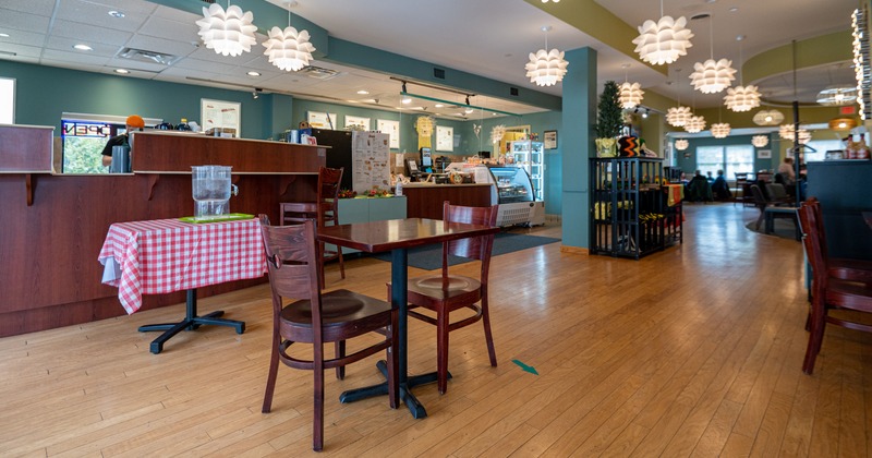 Diner area, table, chairs, food counter behind
