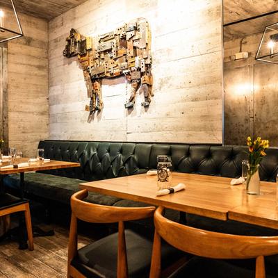 Banquette seating, with a cow shaped decoration on the wall