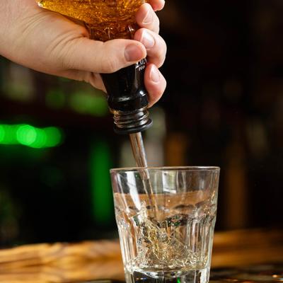 Pouring whiskey in a glass.