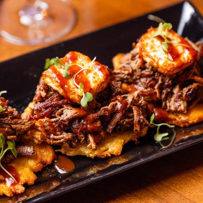 Fried green plantains topped with shredded beef.