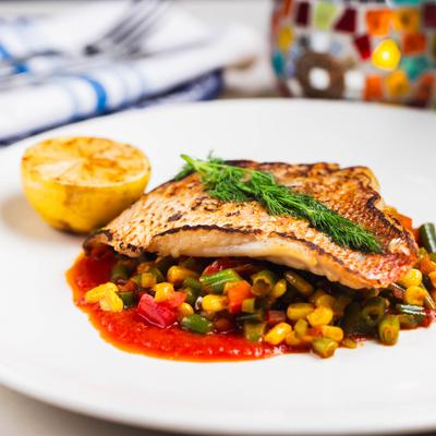 Sauteed Florida Red Snapper served over a medley of veggies.