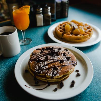 Chocolate Chip Pancakes, Apple and Pecan Waffle, orange juice, and coffee.