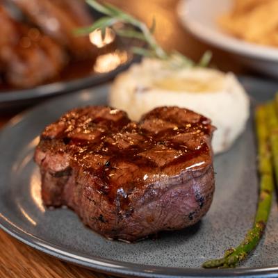 A seared filet mignon, creamy mashed potatoes and green asparagus.