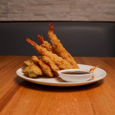 Tempura shrimp and veggies with a soy sauce for dipping.