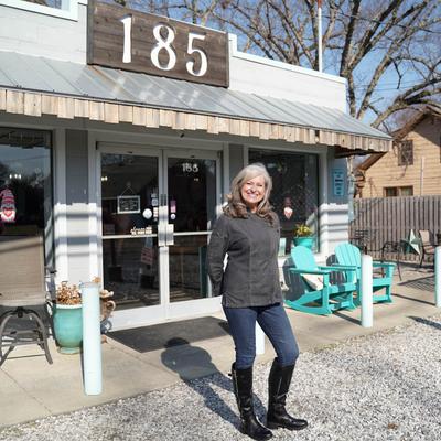 The owner posing for the camera in front of the 185 restaurant.