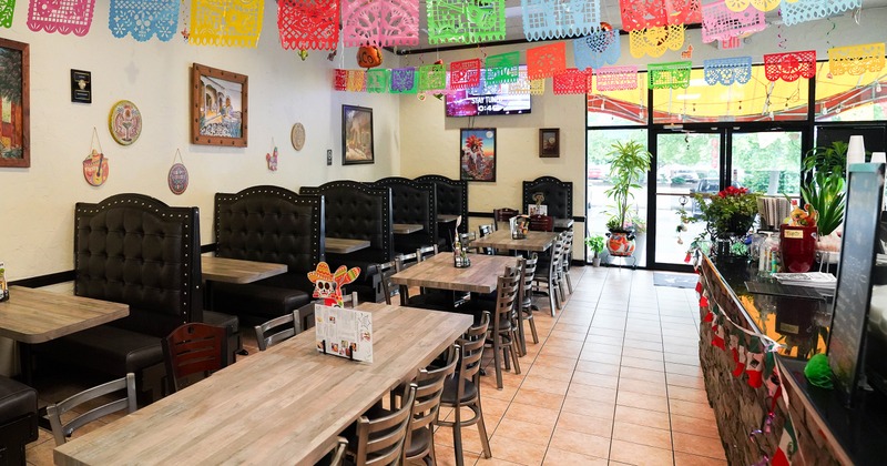 Mexicanvstyle interior dining area decorated with hanging paper ornaments