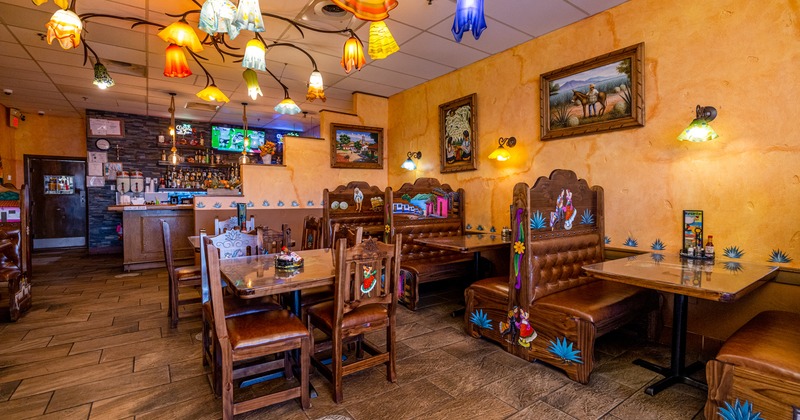 Interior, booths, tables, chairs, counter, lighting, paintings