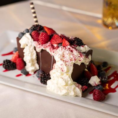 Dark chocolate mousse, with caramel sauce, whipped cream, artisan cookie, and berries.