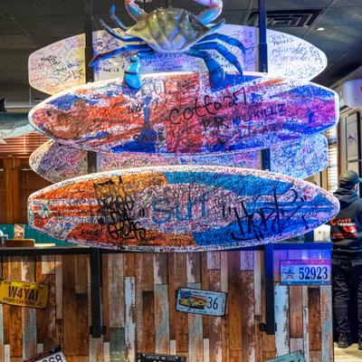 Interior decor, Colorful surfboards with large crab decoration.