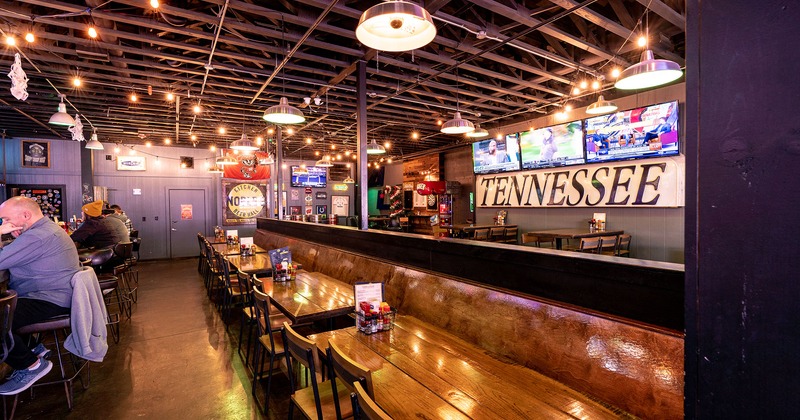 Interior, tables and chairs lined up near bar area