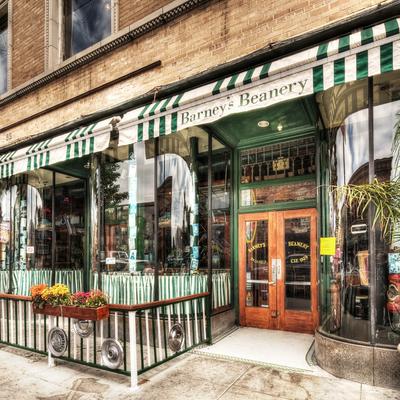 Storefront of Barney's Beanery, featuring a green-and-white striped awning