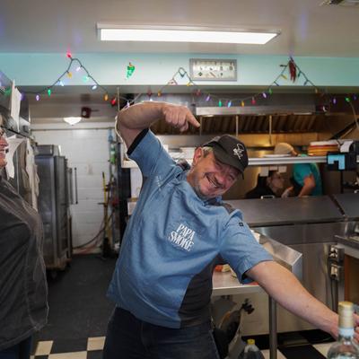 A chef playfully gesturing in the kitchen.